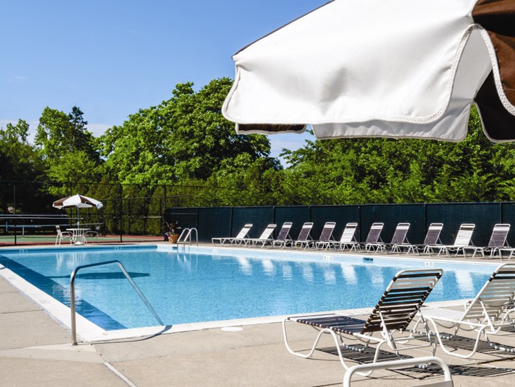 Outdoor Pool with Lounge chairs on the deck at Hillcrest Village, Holbrook, NY, 11741